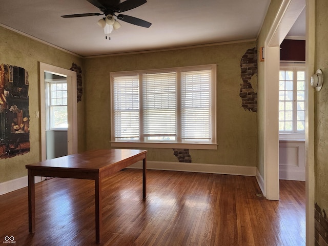 unfurnished dining area with crown molding, hardwood / wood-style floors, and ceiling fan