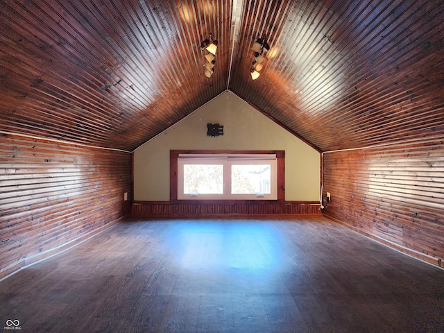 bonus room with dark hardwood / wood-style floors, vaulted ceiling, and wood walls