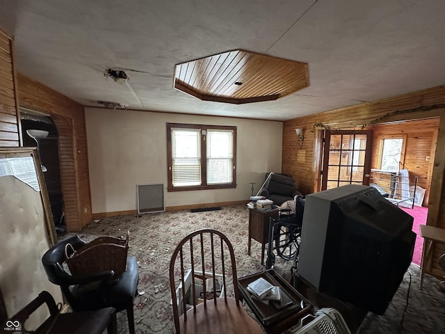 misc room featuring carpet and wooden walls