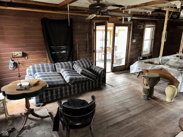 bedroom with wood-type flooring, beam ceiling, and wood walls