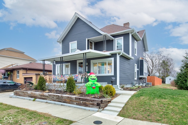 view of front of property with a front yard and a porch