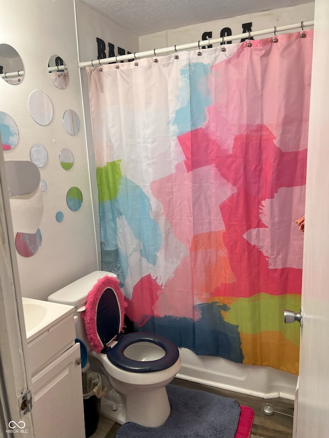 full bathroom with a textured ceiling, vanity, toilet, and shower / bathtub combination with curtain