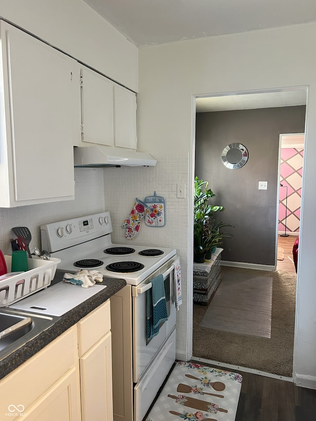 kitchen with white cabinets, white electric range oven, and dark hardwood / wood-style floors