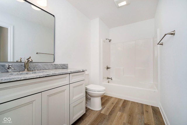 full bathroom with vanity, toilet, wood-type flooring, and bathing tub / shower combination