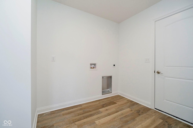 washroom featuring hookup for an electric dryer, washer hookup, and light wood-type flooring