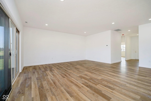 spare room with light hardwood / wood-style flooring