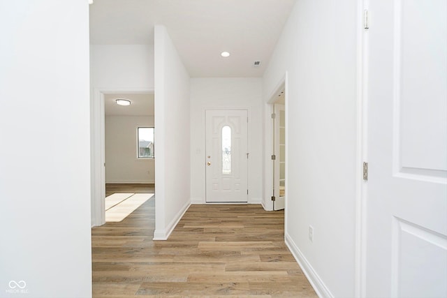 foyer with baseboards, recessed lighting, and light wood-style floors