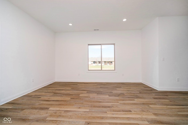 spare room featuring light hardwood / wood-style flooring