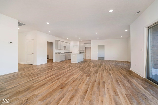 unfurnished living room featuring light hardwood / wood-style floors