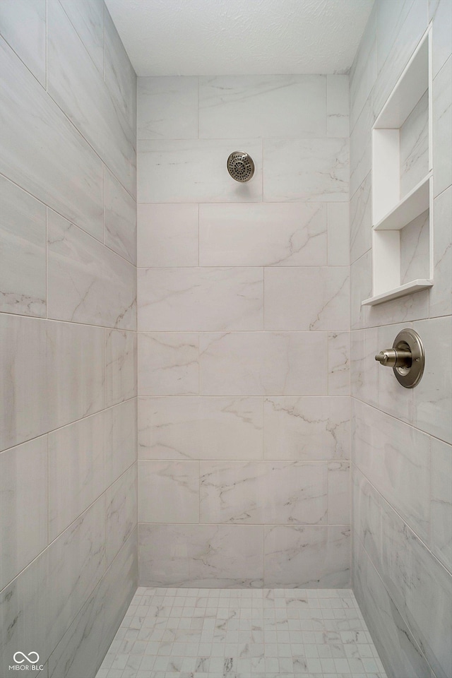 bathroom with a tile shower