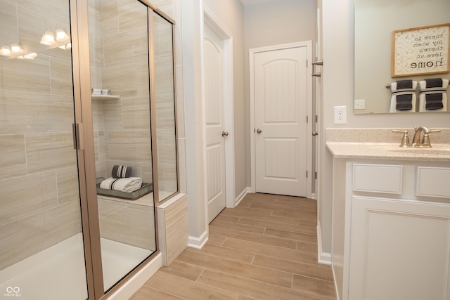 bathroom featuring vanity and a shower with shower door