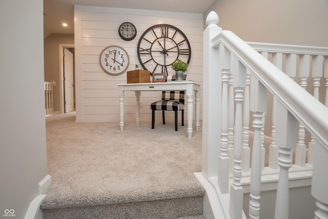 stairway with wooden walls and carpet