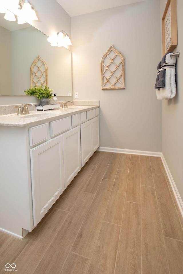 bathroom with vanity and hardwood / wood-style flooring