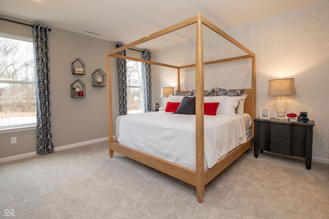 carpeted bedroom featuring multiple windows