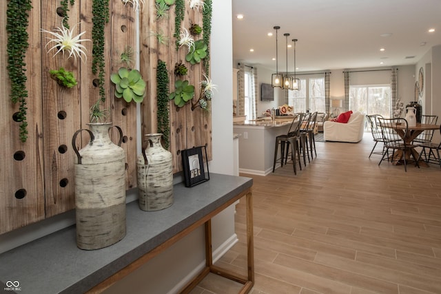 interior space featuring pendant lighting and light hardwood / wood-style floors