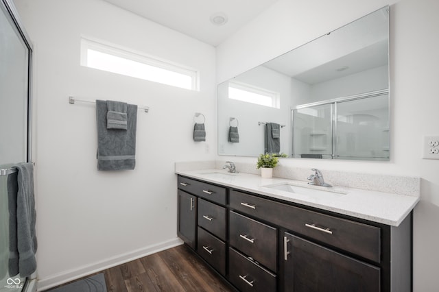 bathroom featuring vanity, wood-type flooring, and walk in shower