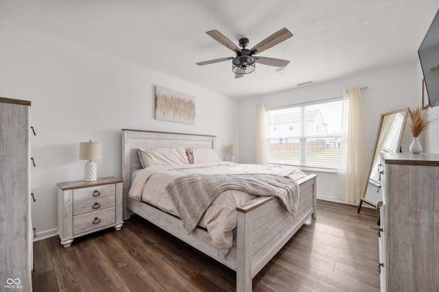 bedroom featuring dark hardwood / wood-style floors and ceiling fan