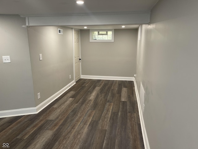 basement featuring dark hardwood / wood-style flooring