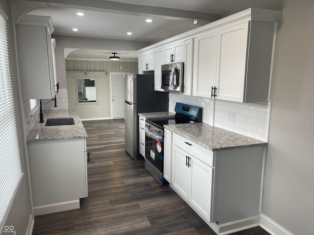 kitchen featuring dark wood-type flooring, white cabinets, sink, light stone countertops, and black range with electric cooktop