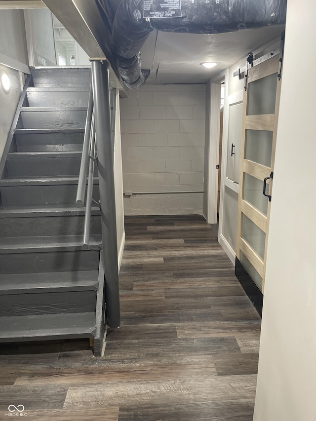 stairway featuring hardwood / wood-style floors and a barn door