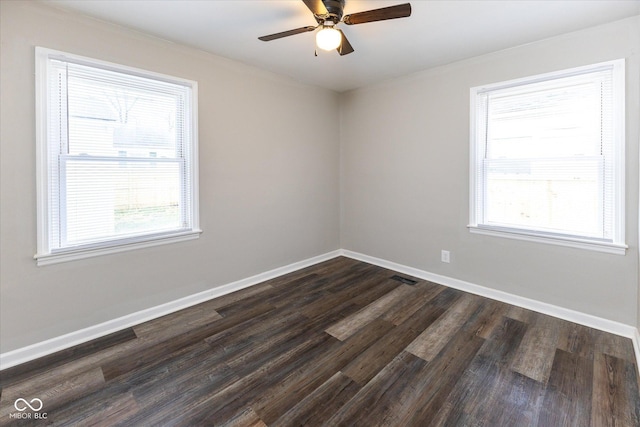 unfurnished room with dark wood-type flooring, ceiling fan, and a healthy amount of sunlight