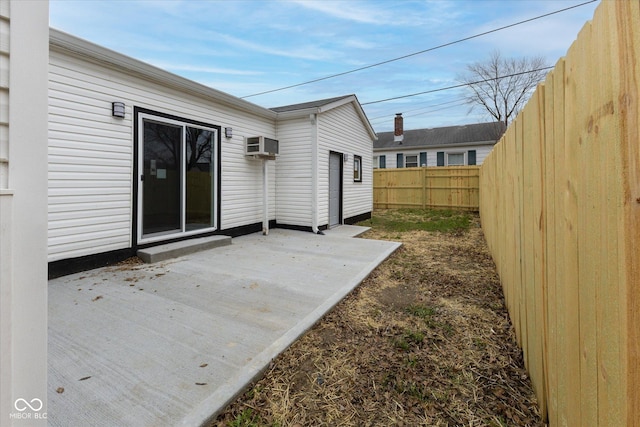 view of patio featuring an AC wall unit