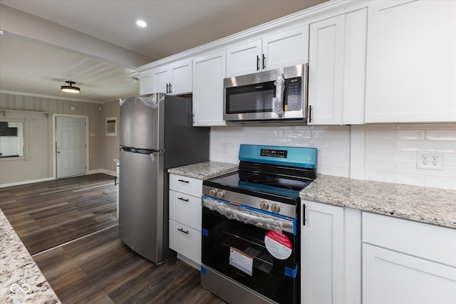 kitchen with decorative backsplash, appliances with stainless steel finishes, light stone counters, dark hardwood / wood-style floors, and white cabinetry