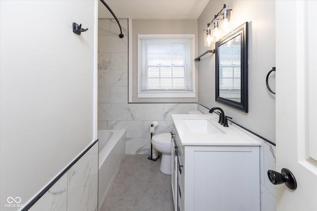 full bathroom featuring vanity, bathtub / shower combination, tile patterned floors, toilet, and tile walls