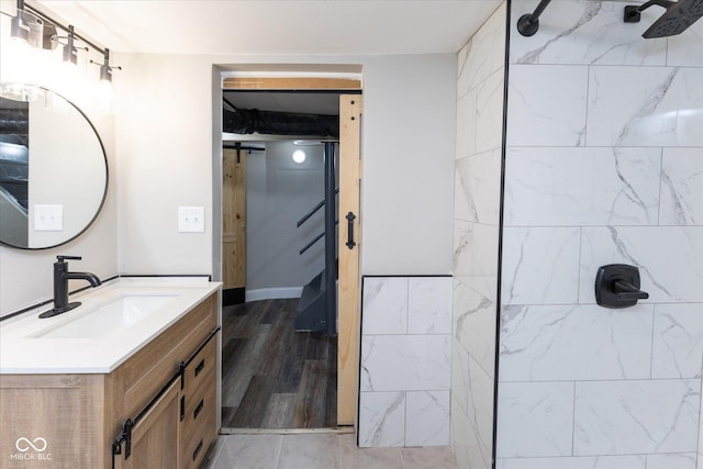 bathroom featuring vanity and tiled shower