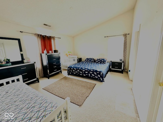 carpeted bedroom with lofted ceiling