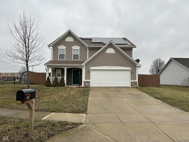 view of property featuring a front yard, covered porch, a garage, and solar panels