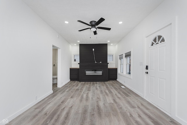 unfurnished living room with ceiling fan and light hardwood / wood-style floors