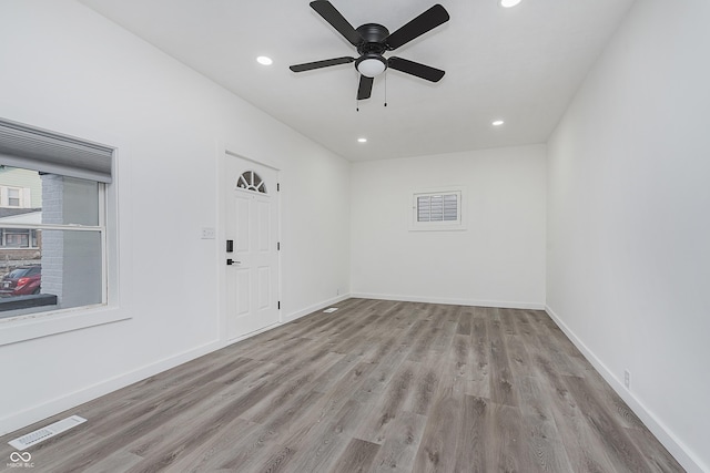 empty room with light wood-type flooring and ceiling fan