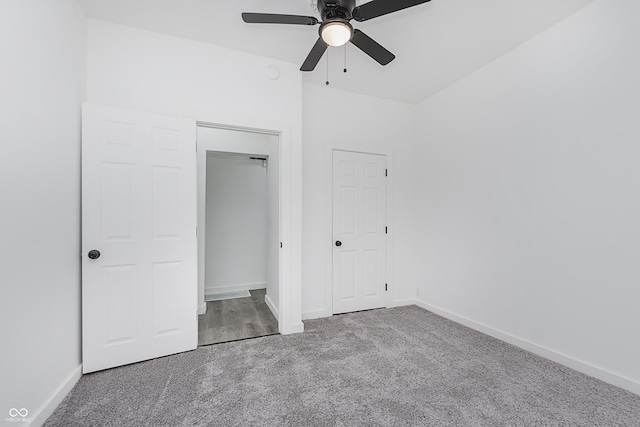 unfurnished bedroom with ceiling fan, carpet floors, and a closet