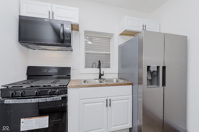 kitchen with sink, white cabinets, and black appliances