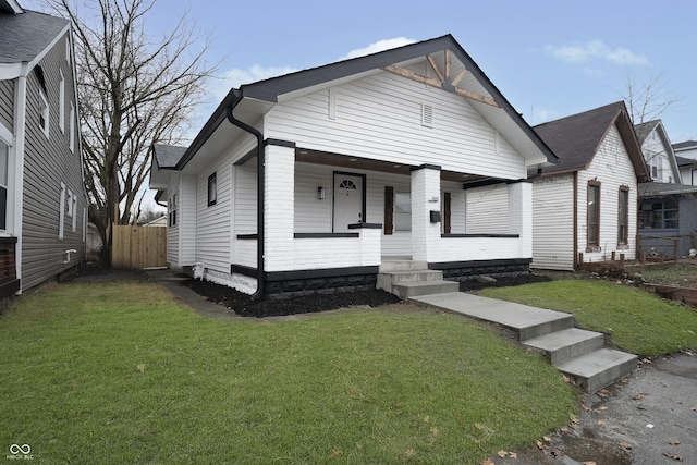 view of front of property with a porch and a front yard