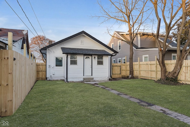 bungalow-style home featuring a front yard