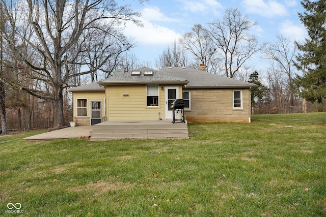 back of property featuring a yard and a patio area