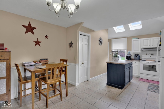 kitchen with white cabinetry, white electric stove, a skylight, and light tile patterned flooring