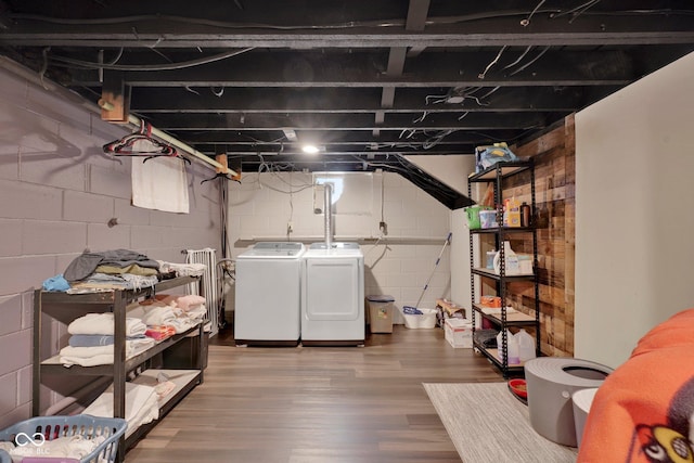 basement with washing machine and dryer and hardwood / wood-style flooring