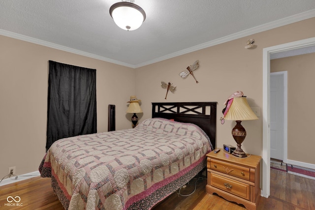 bedroom featuring a textured ceiling, hardwood / wood-style flooring, and ornamental molding