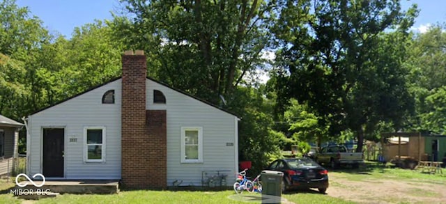 view of side of home featuring a lawn