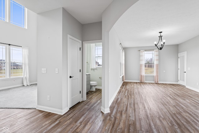 foyer entrance featuring hardwood / wood-style flooring, a chandelier, and a healthy amount of sunlight