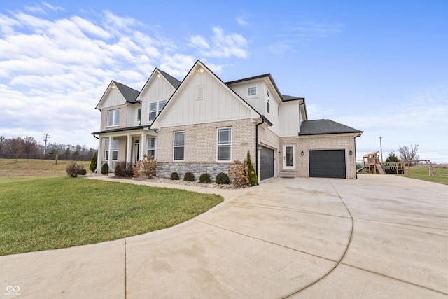 view of front of property with covered porch, a front yard, and a garage