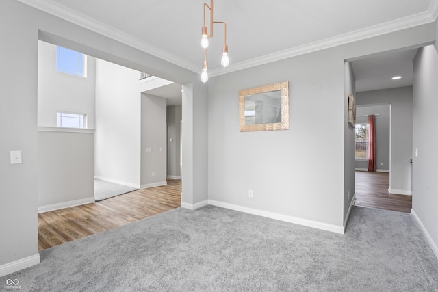 carpeted spare room featuring ornamental molding