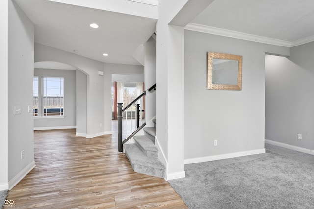 foyer entrance featuring light hardwood / wood-style floors and crown molding