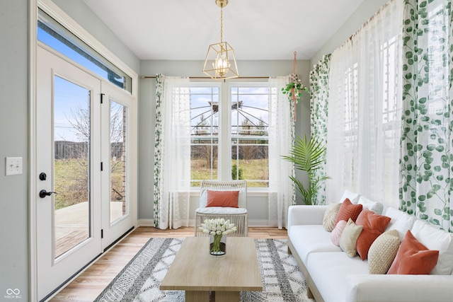 sunroom / solarium with a chandelier and a healthy amount of sunlight