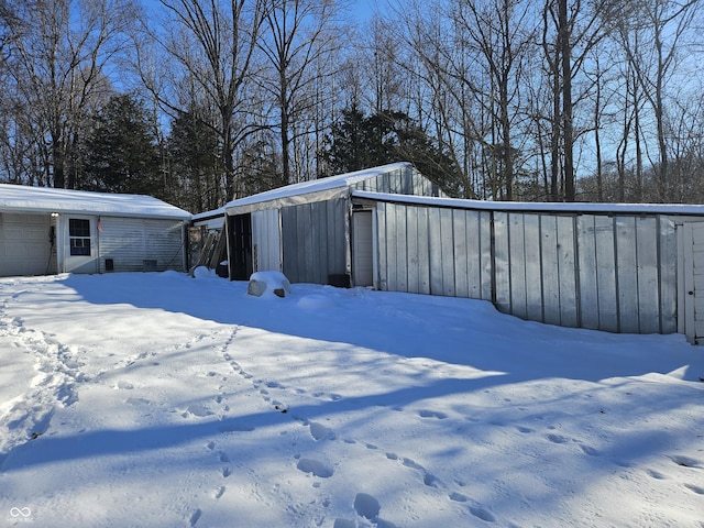 yard layered in snow featuring an outdoor structure