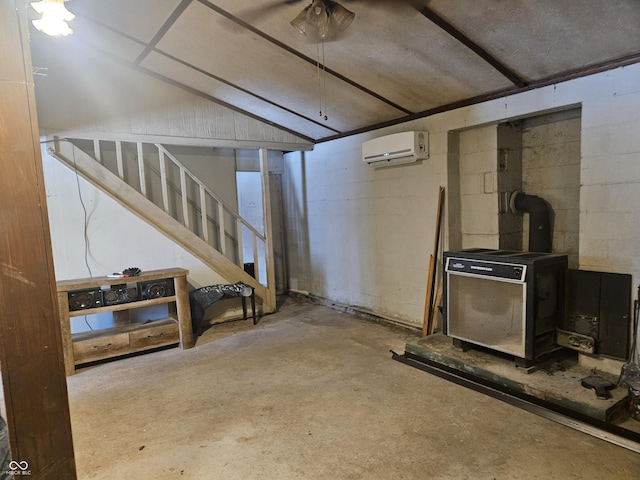 basement with an AC wall unit and a wood stove