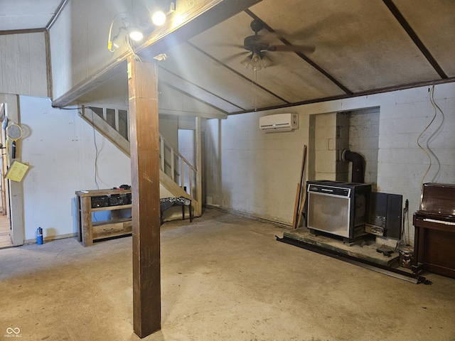 basement featuring a wood stove and a wall unit AC